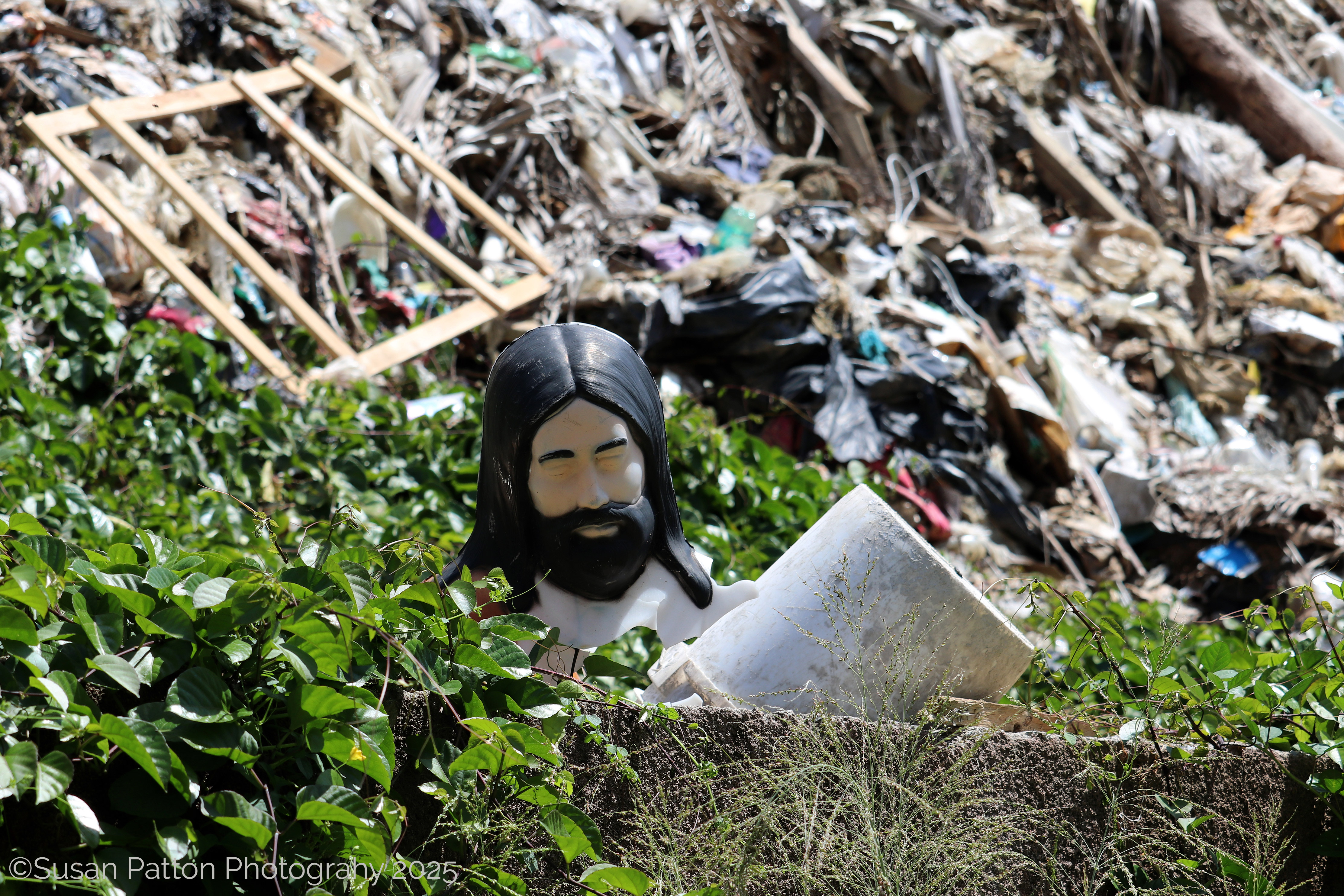 Plastic Jesus in the Dump, Roatan, Honduras photograph taken by Susan Patton